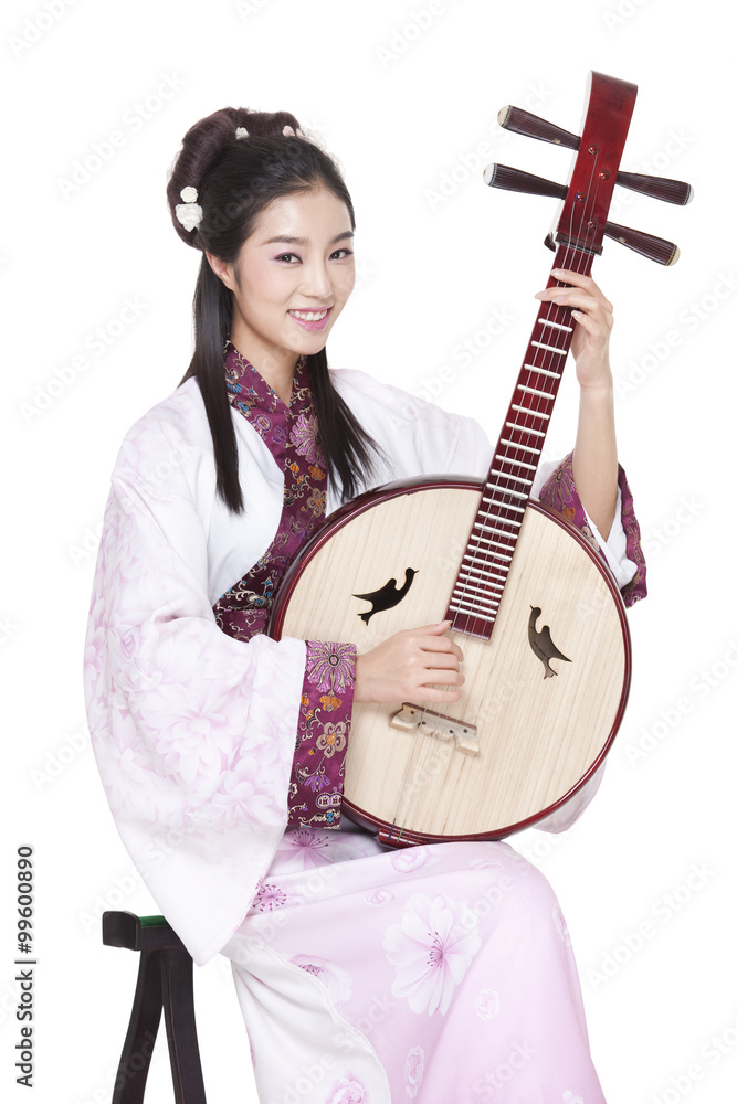 Young woman in Chinese traditional costume plucking classical musical instrument