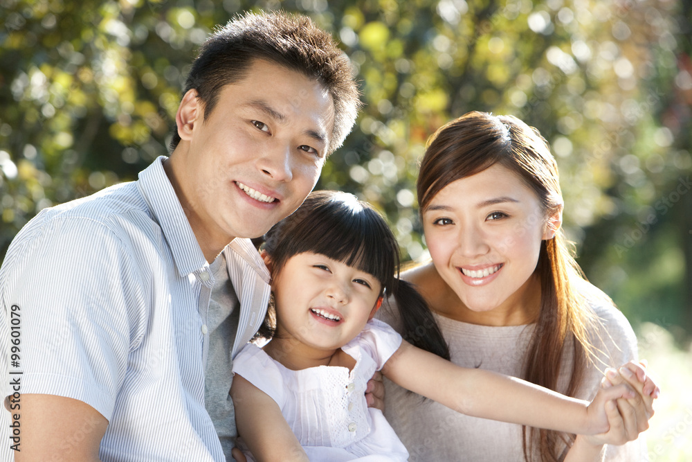 Young family portrait outdoors