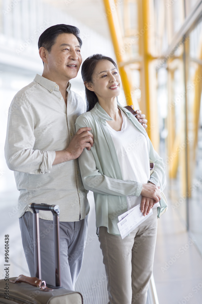 Mature couple waiting at airport