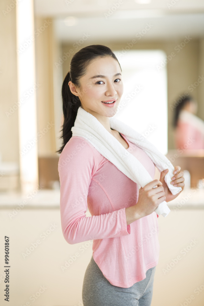 Portrait of young woman with towel