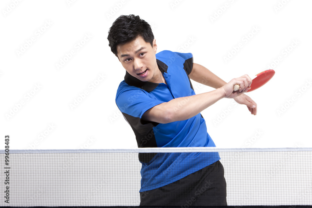 Table tennis player swinging