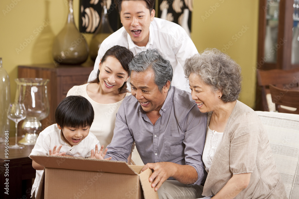 Happy family opening a carton with surprise