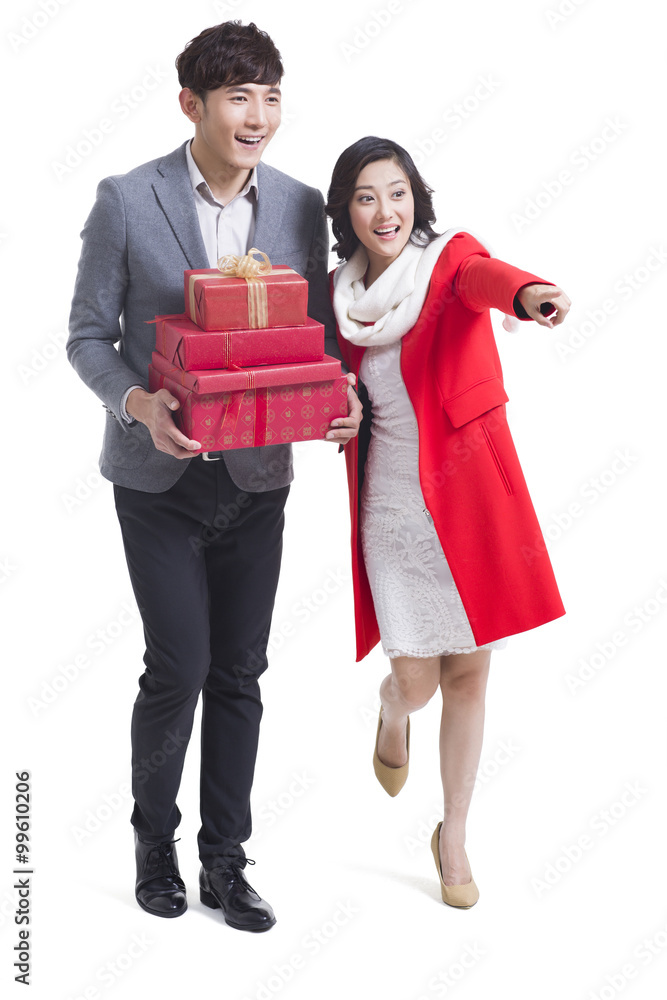 Happy young couple with gifts looking at view