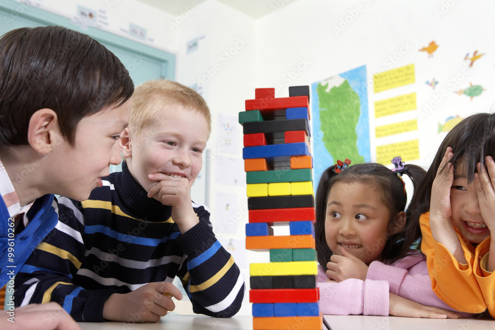 Children Looking At Tower Of Blocks