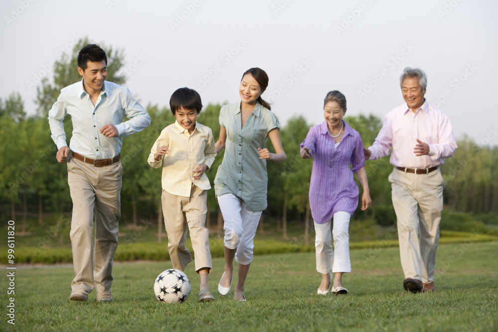 Family playing soccer together