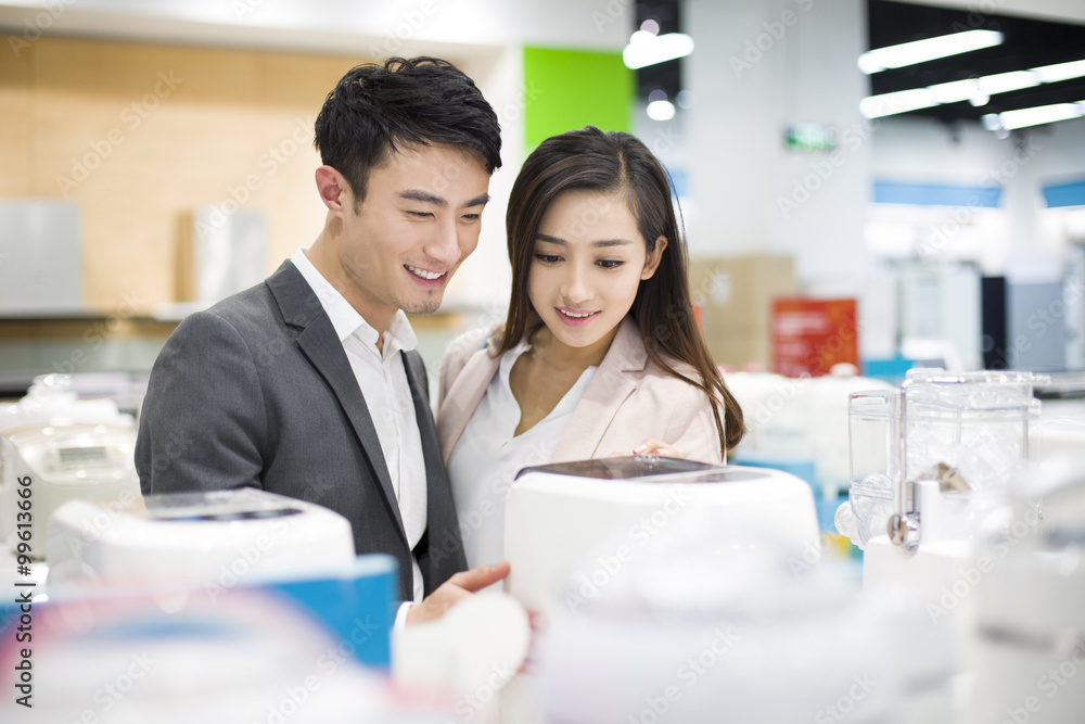 Young couple shopping in electronics store