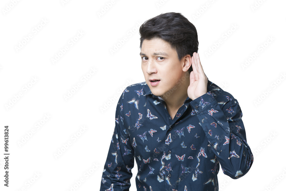 Young man cupping ear to listen