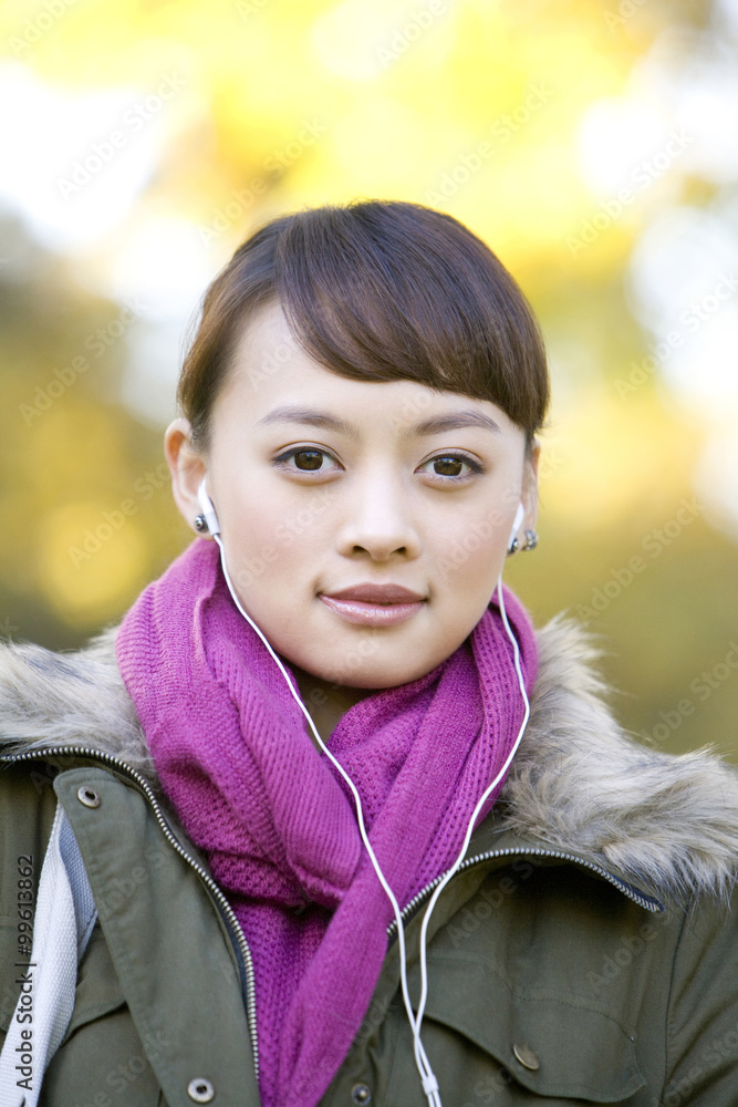 Young Woman Listening to MP3 Player 