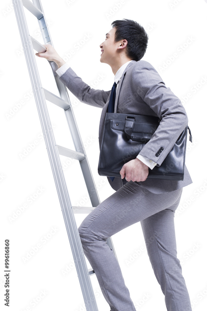 Businessman climbing ladder