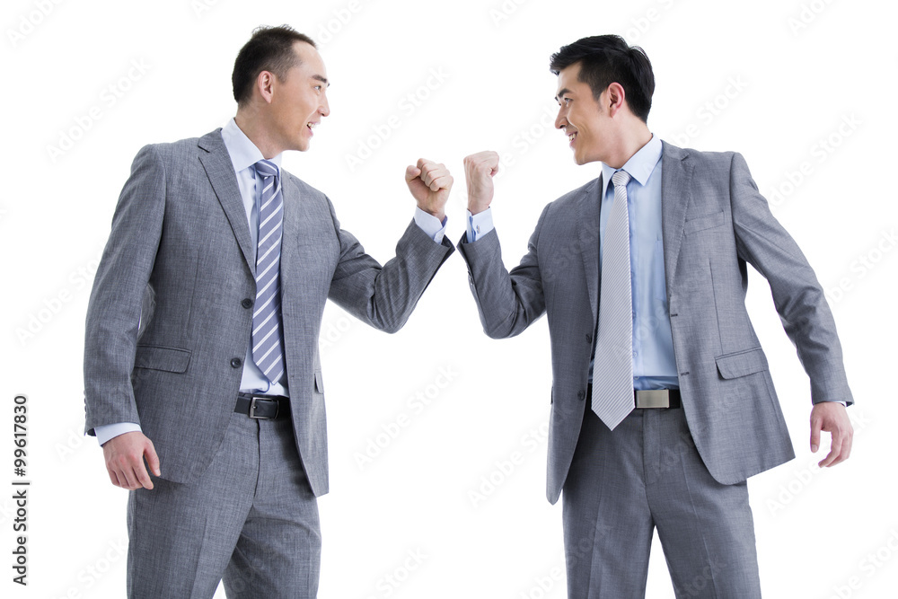 Businessmen punching the air