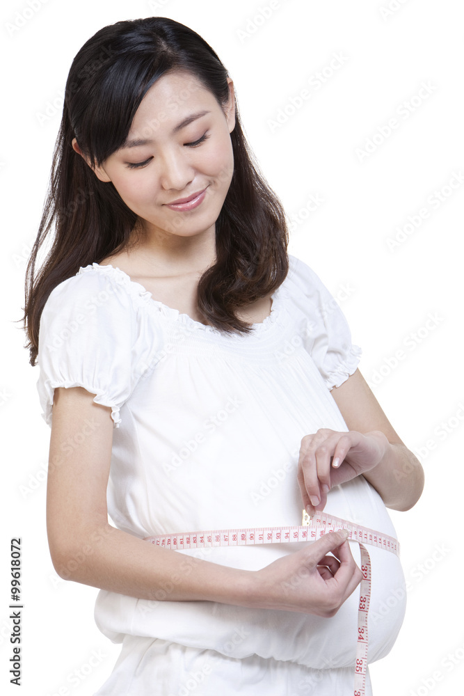 Pregnant woman measuring waist