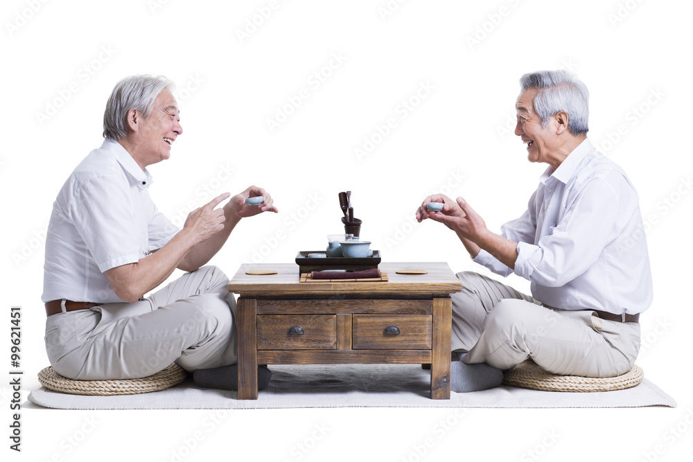 Male senior friends chatting over tea