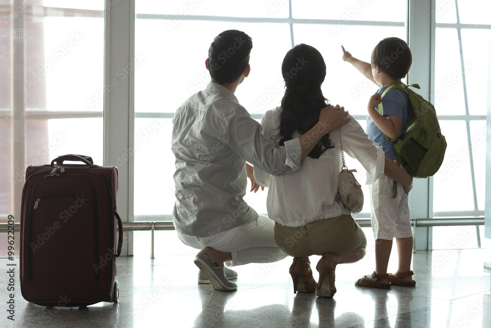 Young family looking at view at the airport