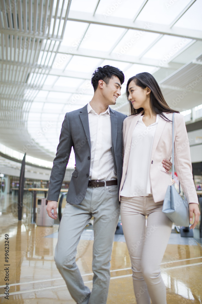 Young couple walking in shopping mall