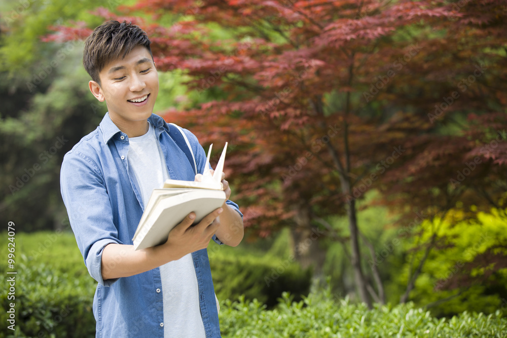 Male college student reading a book