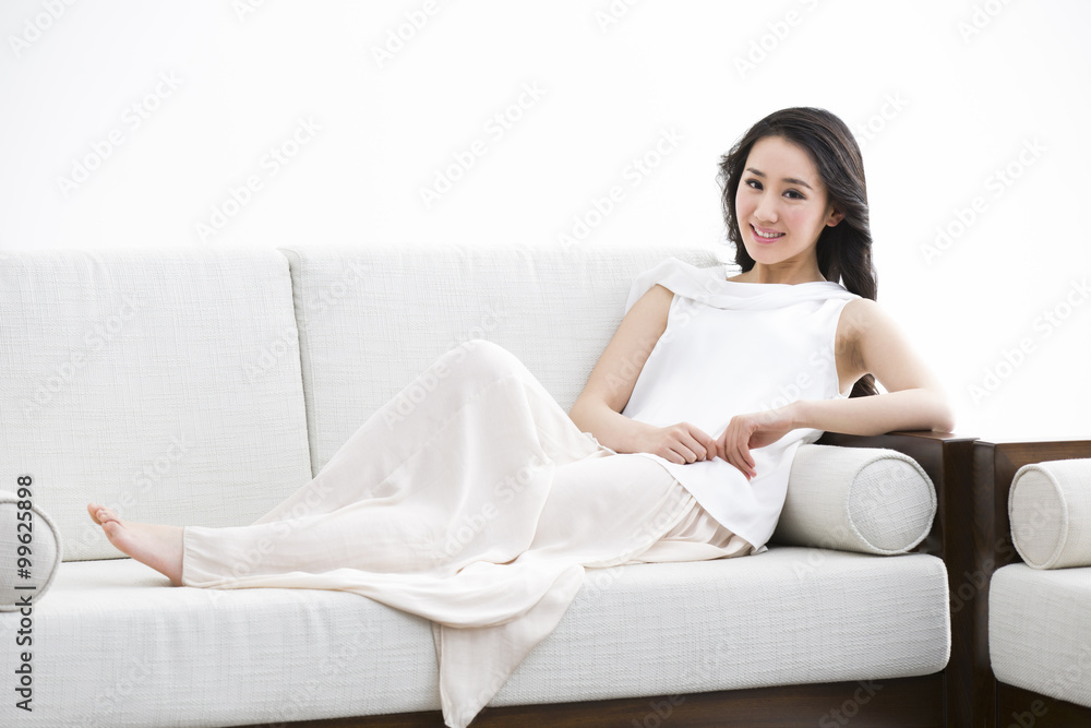 Beautiful young woman relaxing on sofa