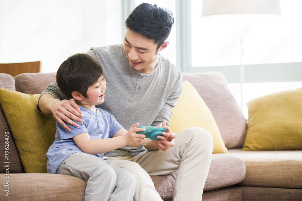 Father and son playing video game