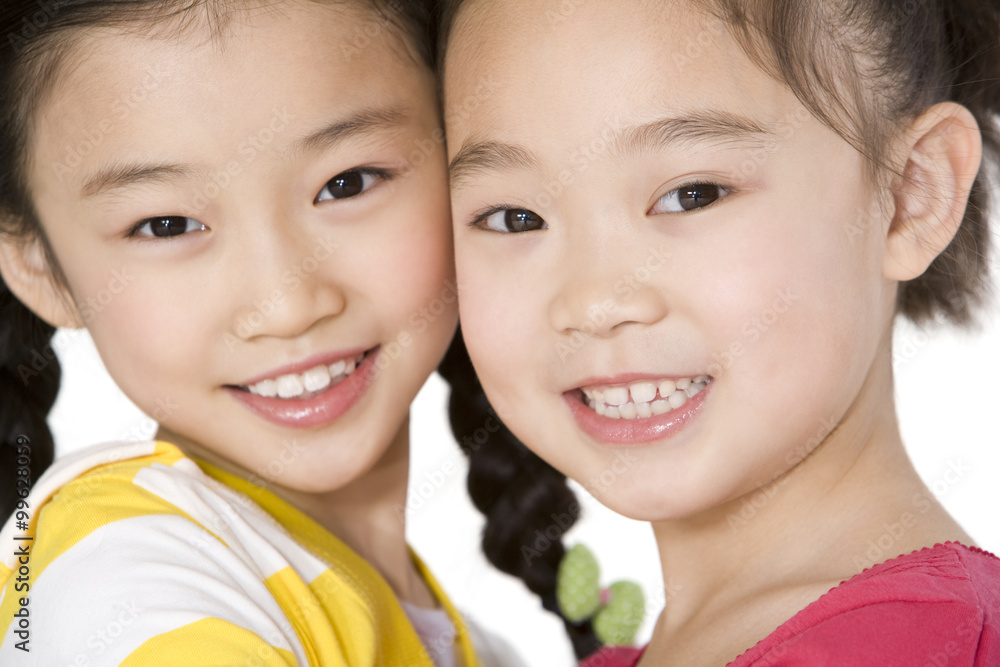 Two friends standing side by side, close up