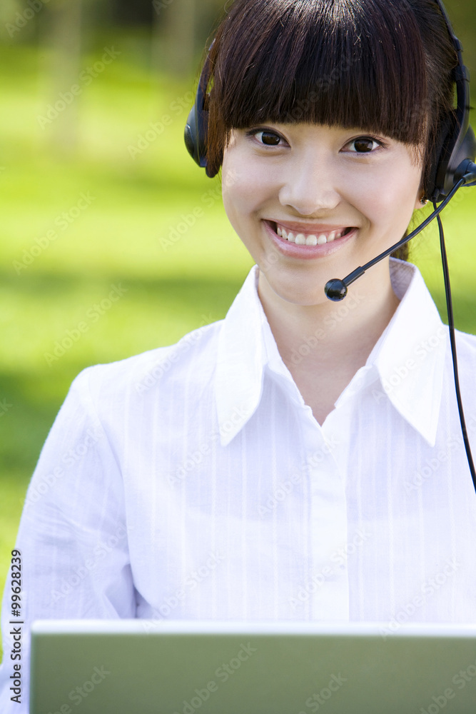 Woman in park with headset