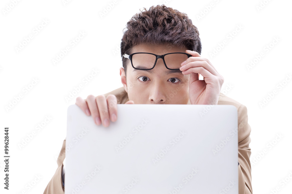 Fashionable businessman with laptop looking astonished