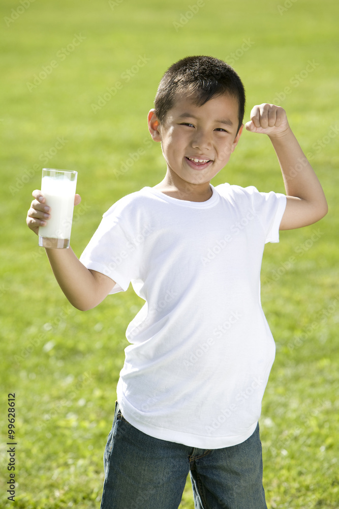 Young boy holding a glass of milk