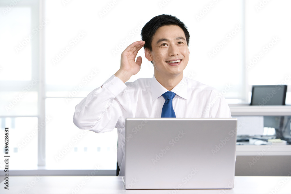 Happy office worker at his desk