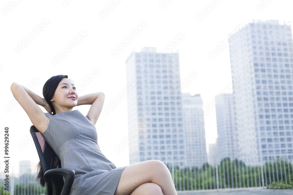 Young businesswoman with head in hands outdoors