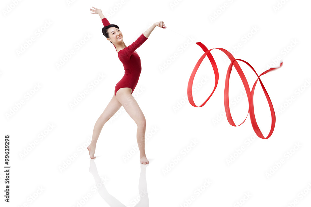 Female gymnast performing rhythmic gymnastics with ribbon