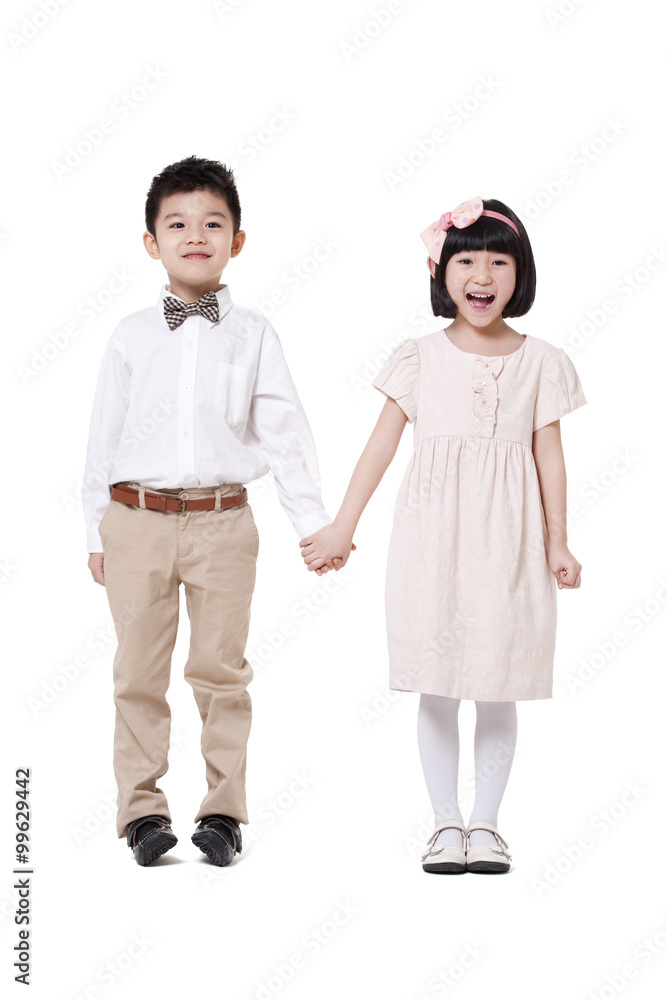 Cute boy and girl hand in hand standing