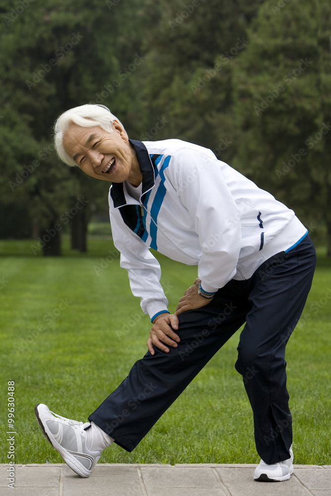 Senior Man Stretching in a Park