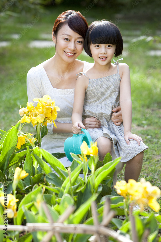 Mother and daughter having fun in garden