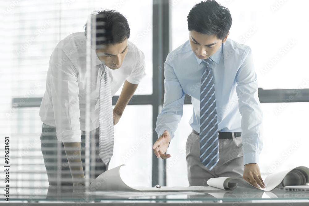 Young businessmen talking in office