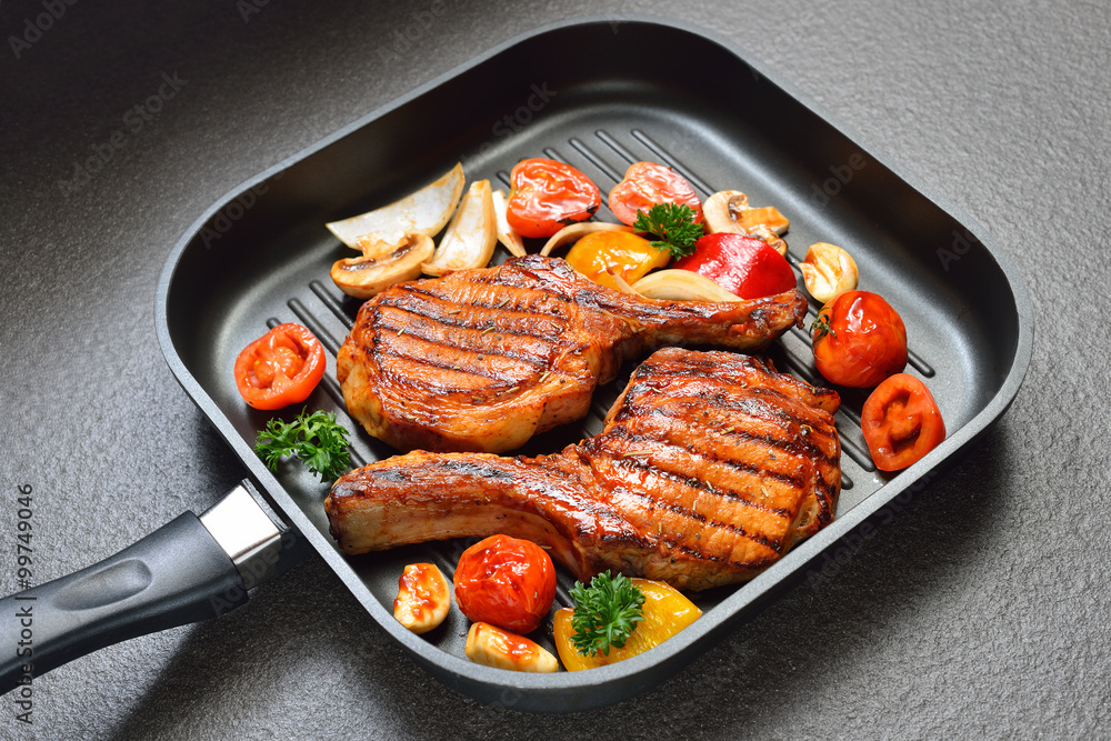 Grilled pork chops and vegetables on the grill pan