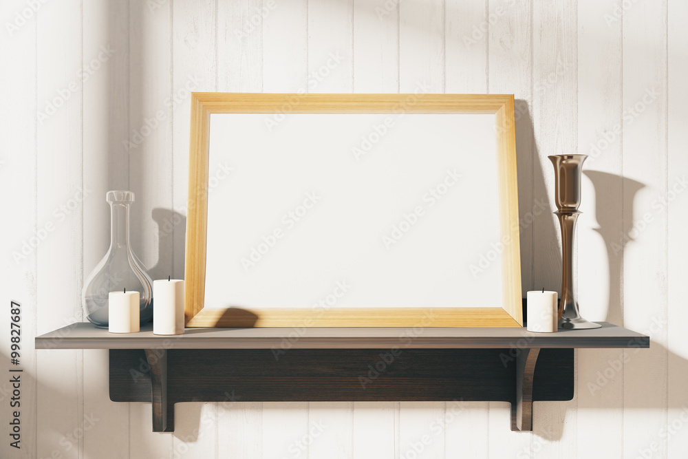 Blank white picture frame with candlesticks on brown wooden shel