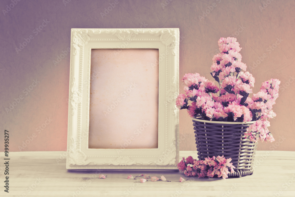 White vintage photo frame with sweet statice flower in basket 