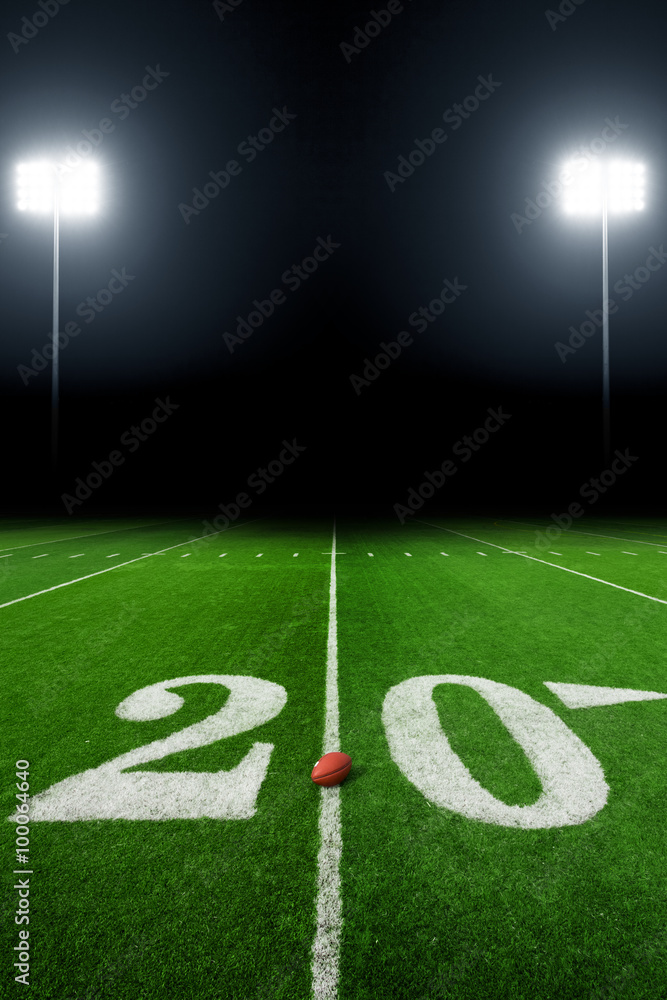 Football field illuminated by stadium lights