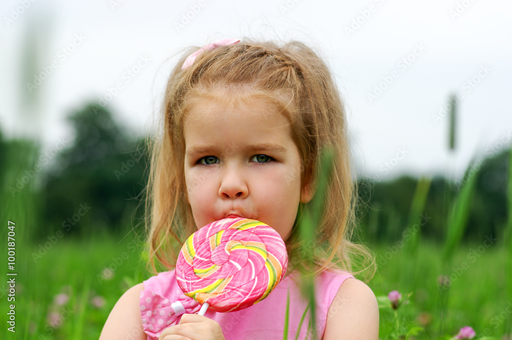  little girl eating a lollipop