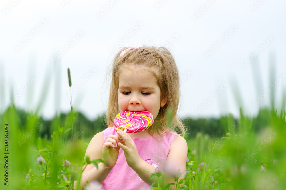  little girl eating a lollipop