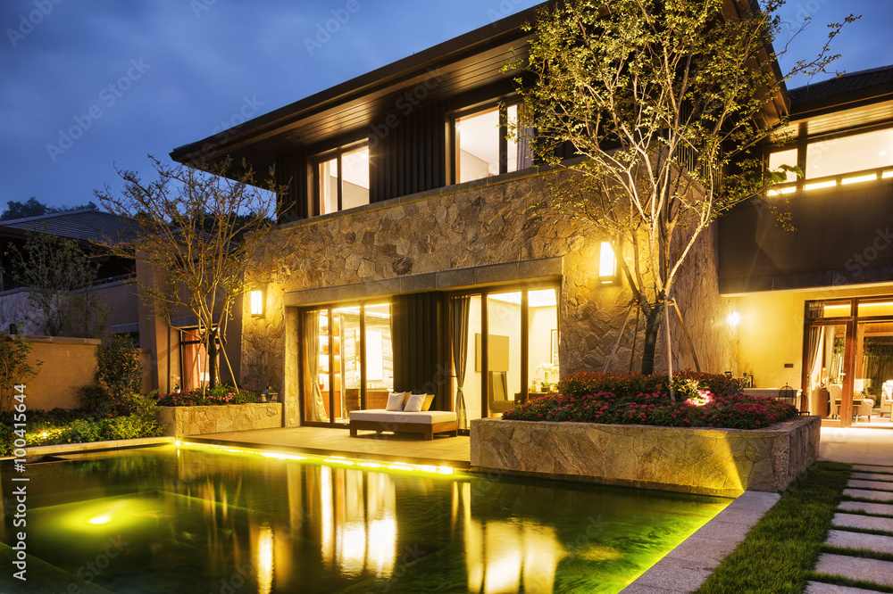 exterior of modern building near pond at night