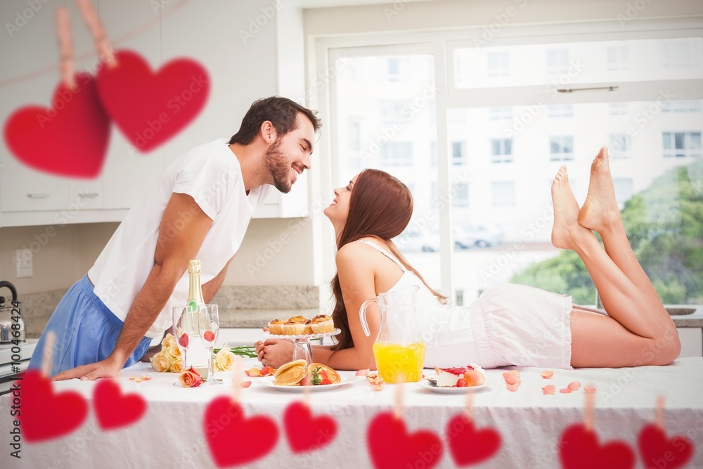 Composite image of young couple having a romantic breakfast