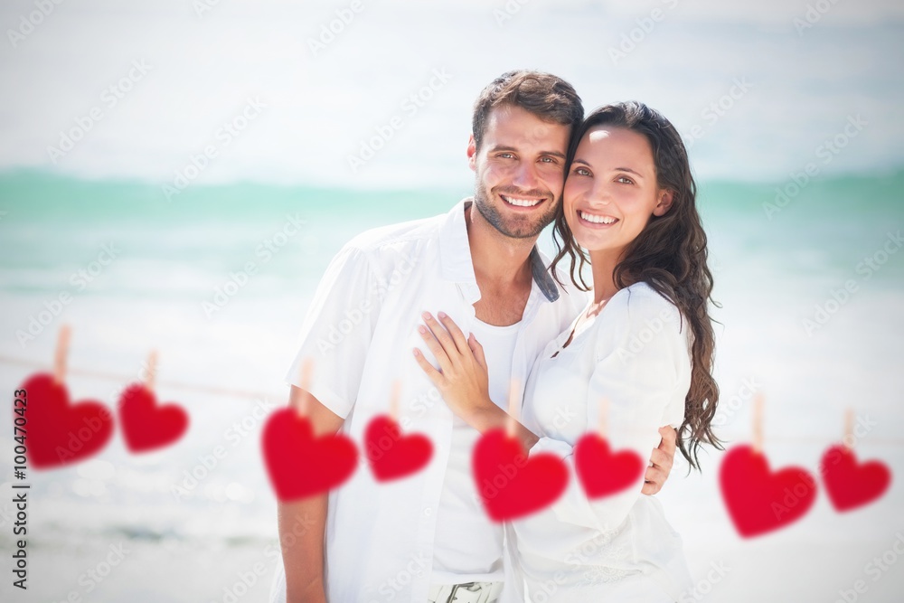 Composite image of happy couple looking at camera 