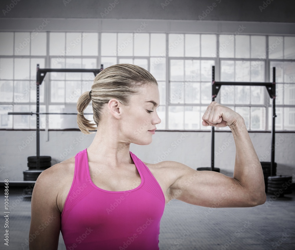 Composite image of mid section of muscular woman flexing muscle