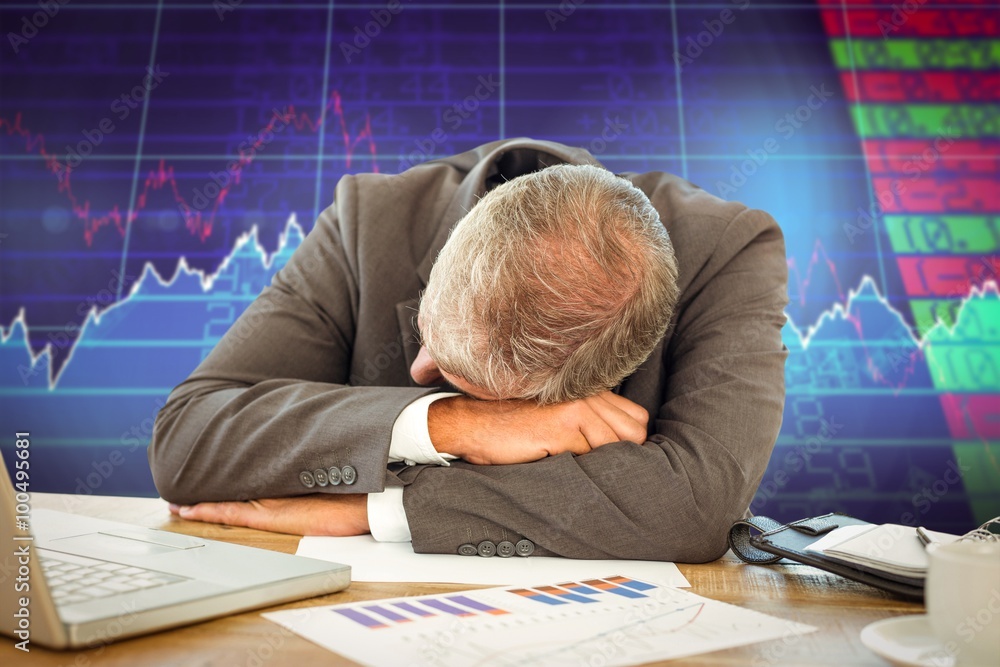 Composite image of tired businessman resting on desk