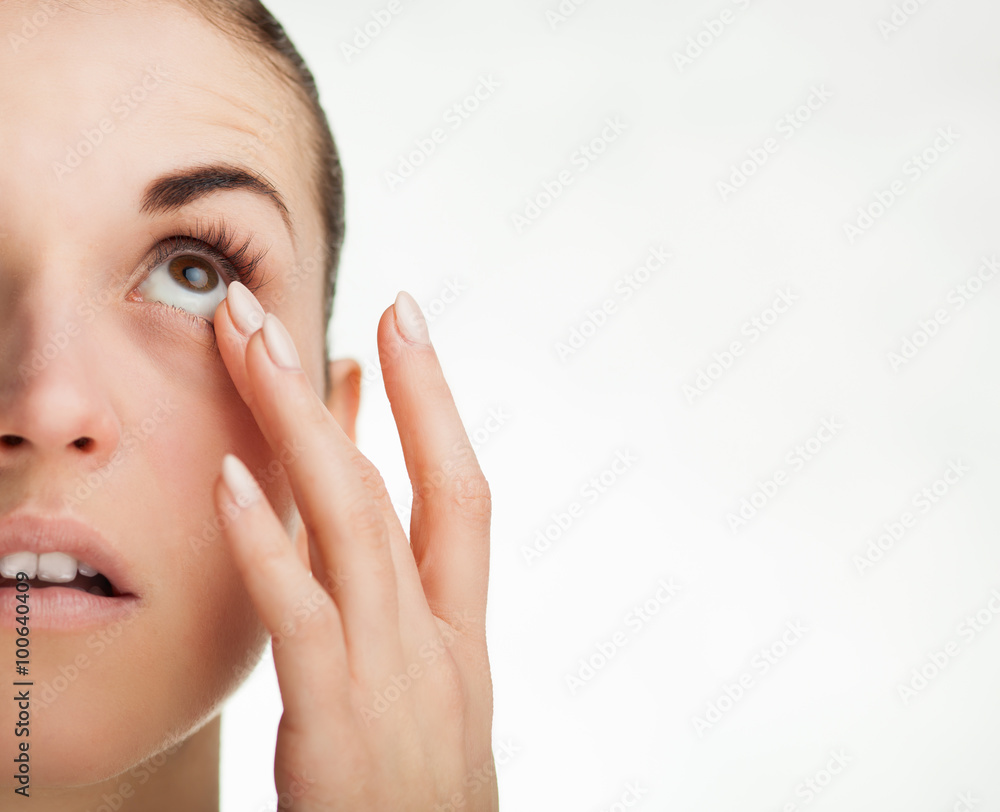 Woman touching her eye concept of healthcare