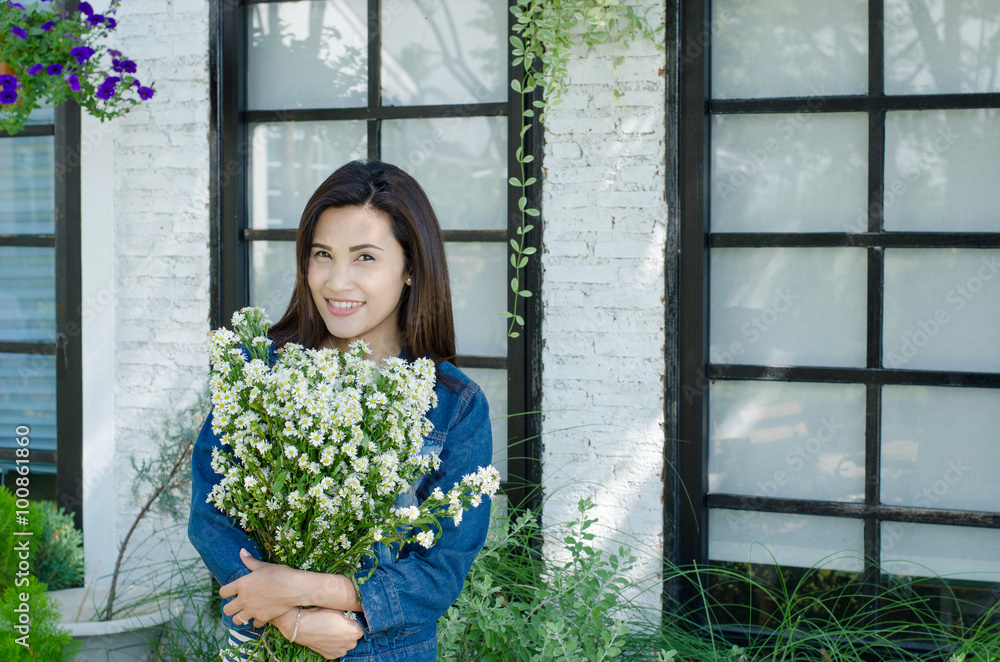 Beautiful asian girl with flower in garden