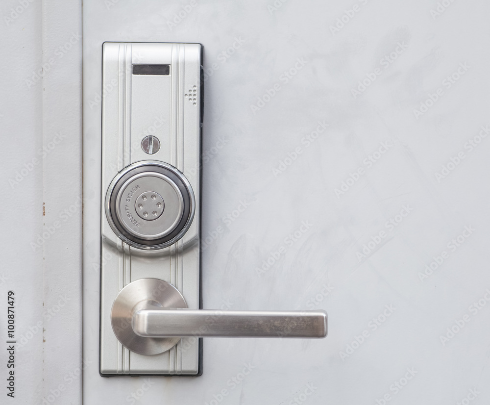 Modern door handle with security system lock on metal door