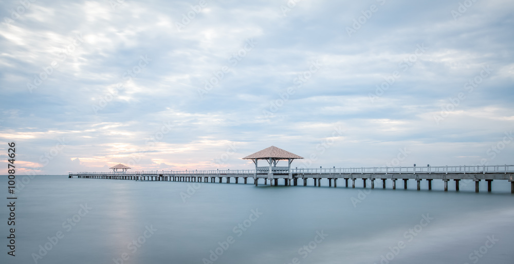 Long wood bridge at sea in sunset time