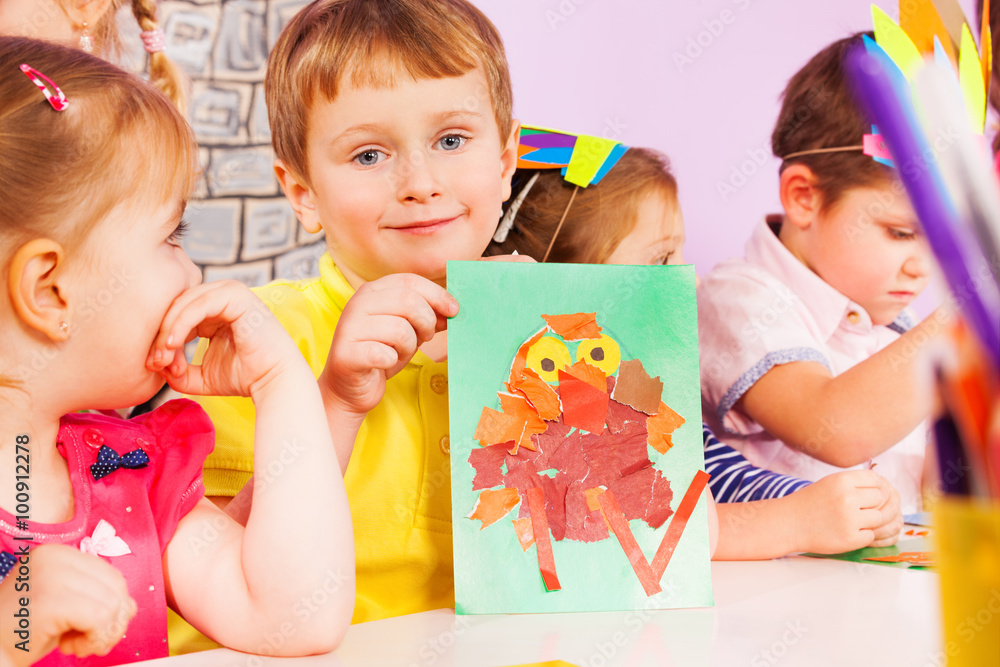 Boy in crafting class showing his work