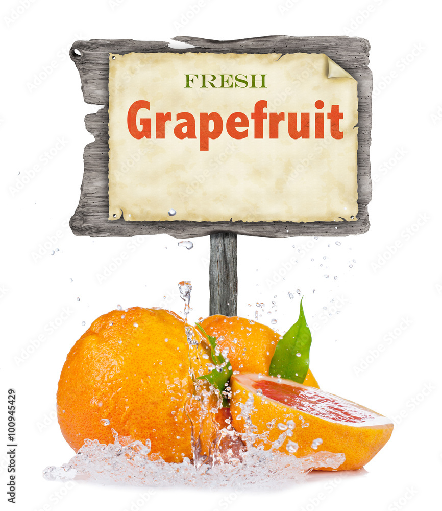 Fresh grapefruit in water splash on white