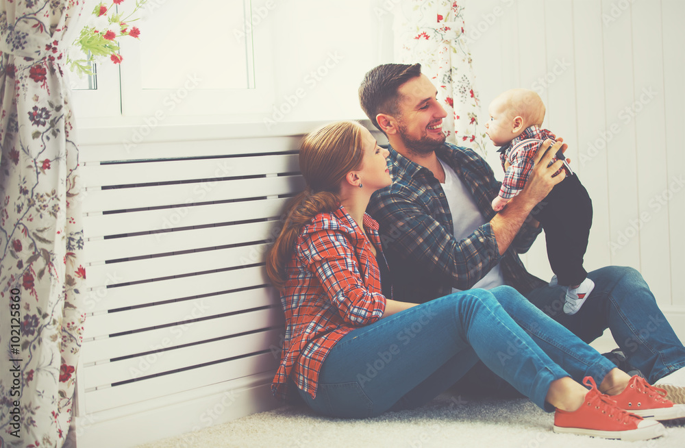 happy family mother and father playing with a baby